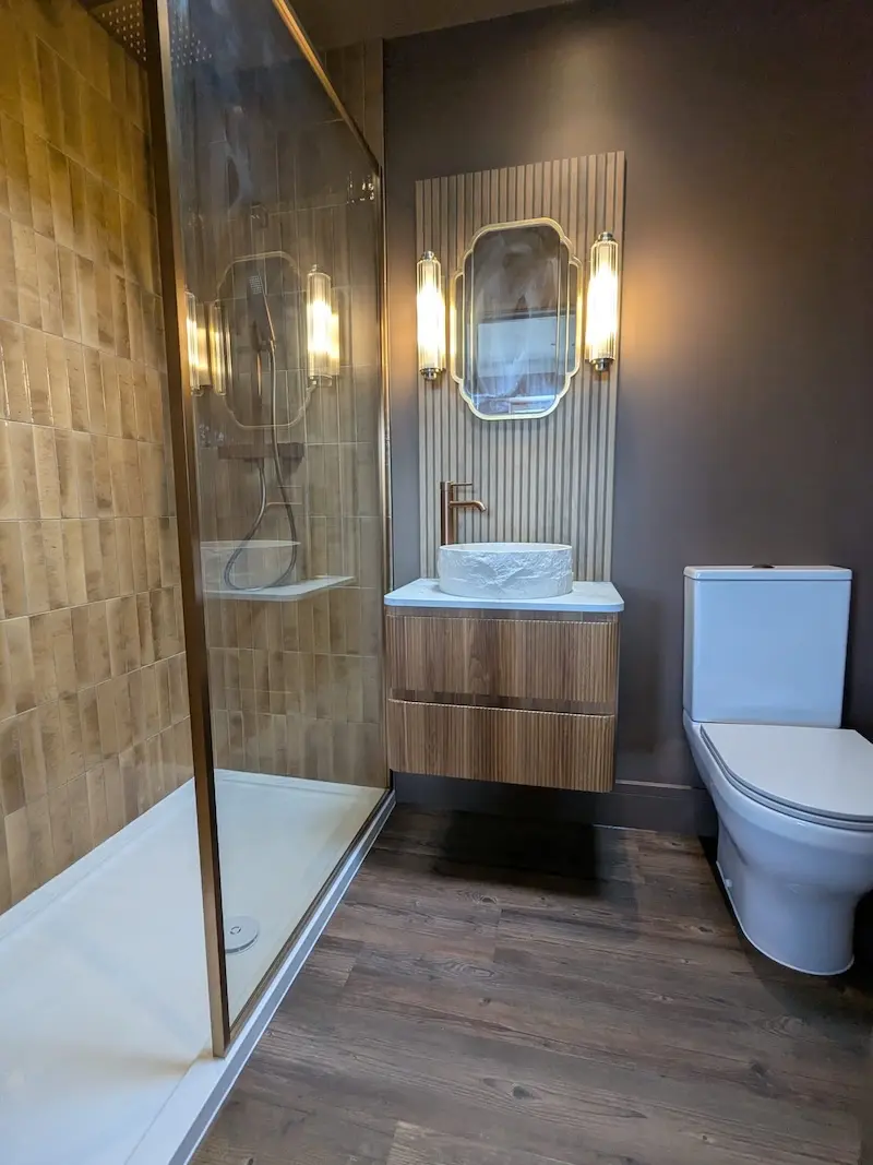 Victorian style bathroom featuring sink, mirror and wall lights