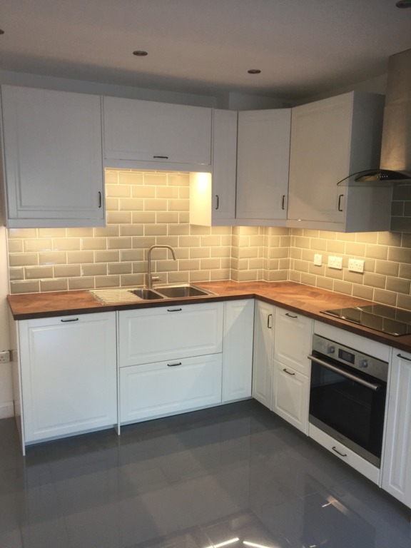New white kitchen (shaker-style), with under cupboard lighting and wooden worktop